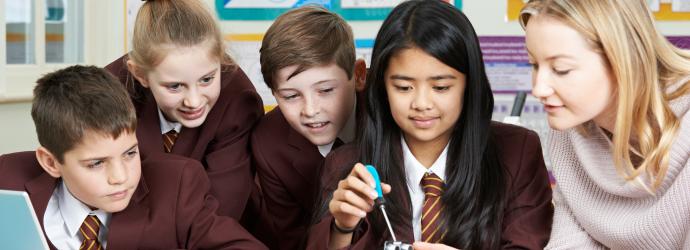 group of students in a STEM lesson with teacher - secondary age