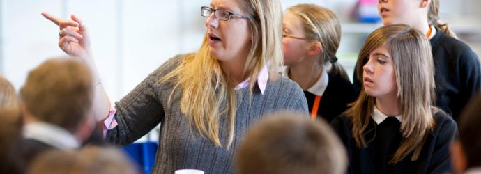 Female teacher with secondary school pupils in a lesson 