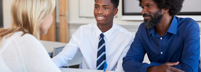 Secondary age pupil with parent and teacher