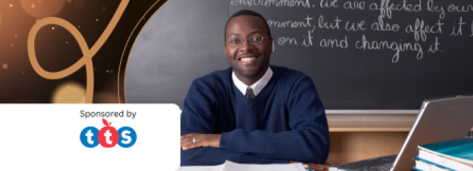 Teacher sits at desk