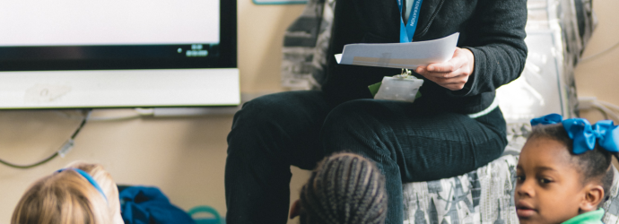 Teacher speaking to Children in a primary classroom