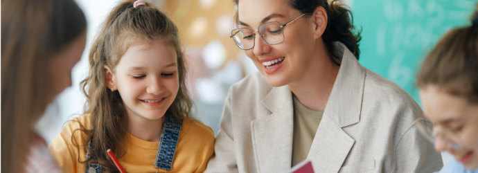 teacher supporting pupils in a classroom
