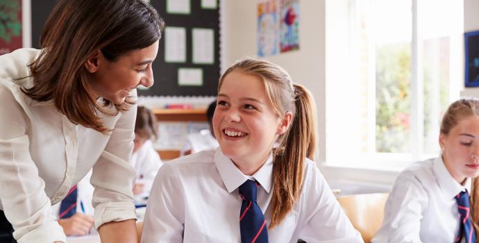 Pupil helping secondary age school pupil