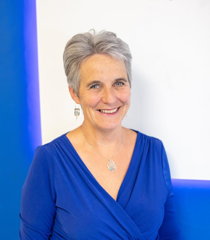 A picture of Al Parr, RSL for West Midlands. Al has short silver hair and is wearing a blue top. She is smiling at the camera.