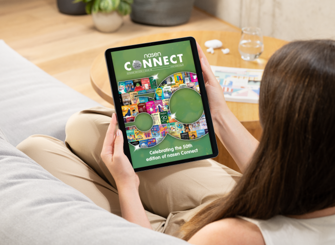 a woman holding a tablet displaying the front cover of nasen Connect