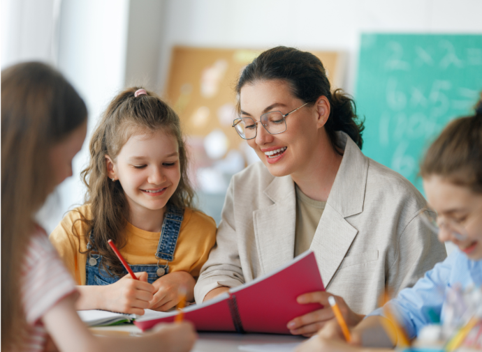 teacher supporting pupils in a classroom